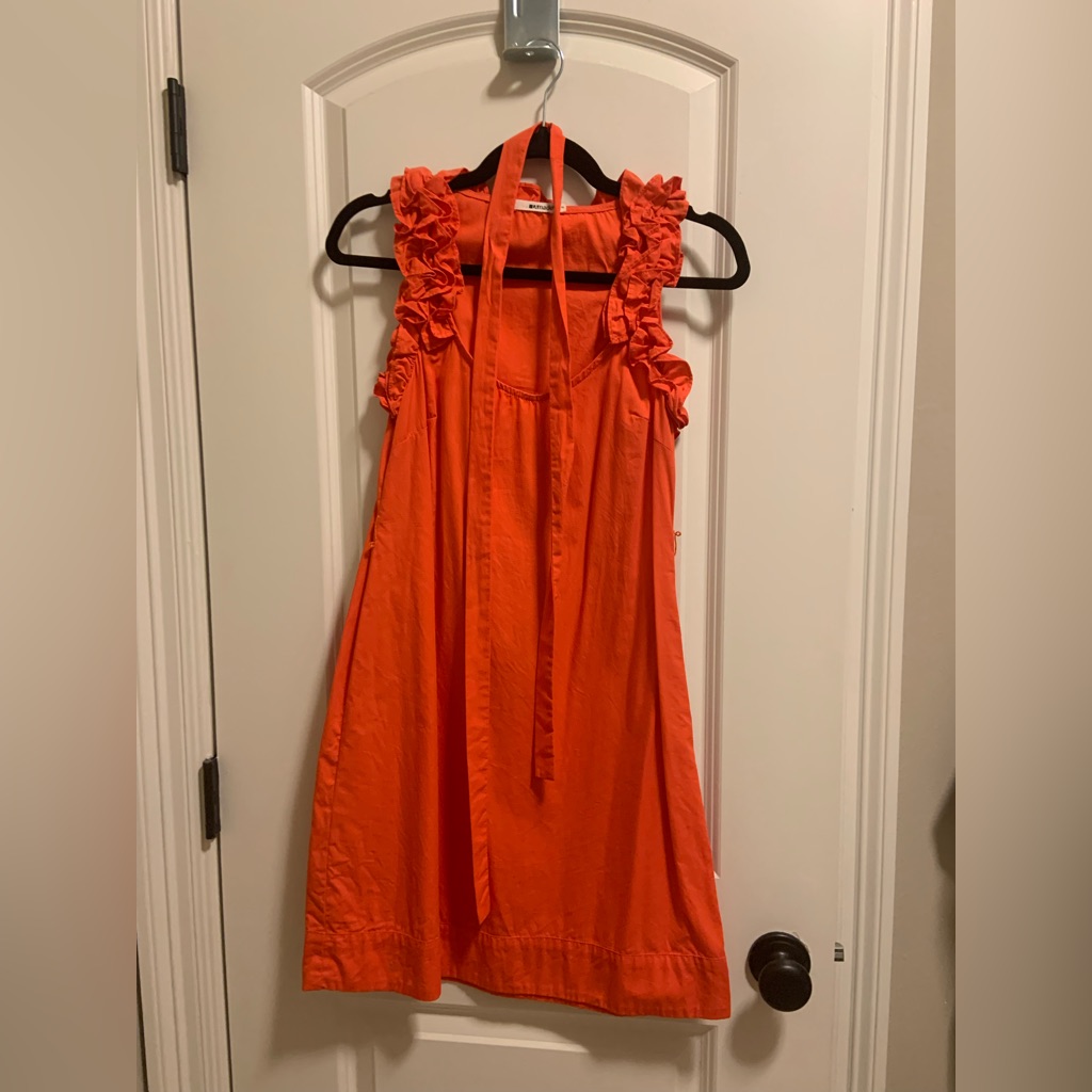 Orange Swing Dress With Belt And Ruffle Detail Around Neck.